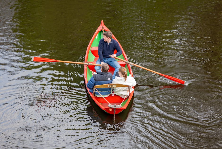 A family of three rowing on a calm river in England, enjoying a peaceful afternoon.